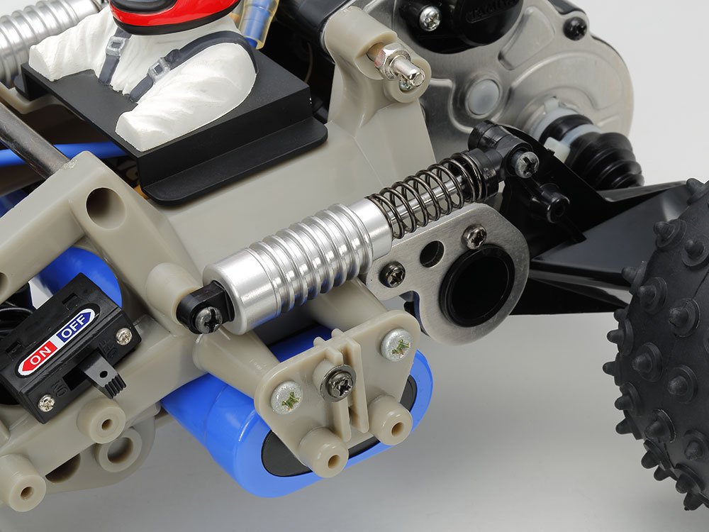 The trailing arm type rear suspension is equipped with an aluminium oil-filled Shock. In addition, a heavy running battery is mounted at the lowest position of the frame to lower the centre of gravity.