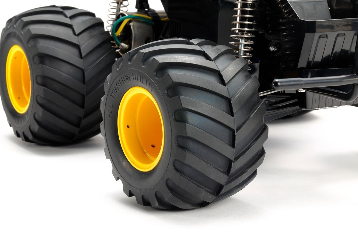 115mm diameter hollow rubber rug pattern tyres are attached to yellow one-piece rims.
