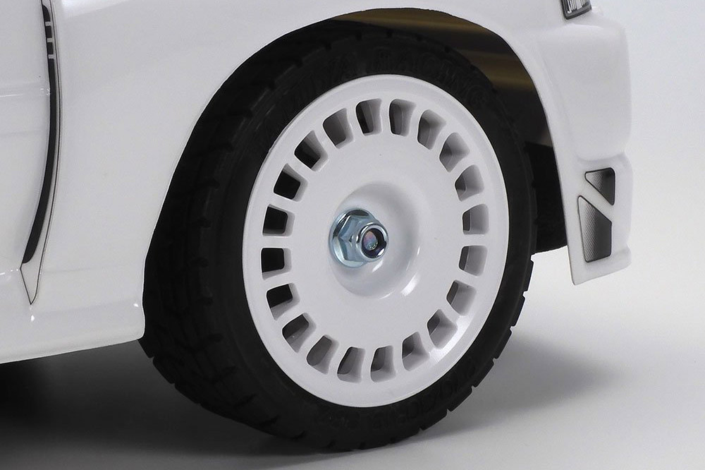White dish wheels are in keeping with the simple look, and are paired with treaded tires.